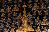 Wat Xieng Thong temple in Luang Prabang, Laos. The facade of the sim decorated with gold stencilling on a black lacquer background.